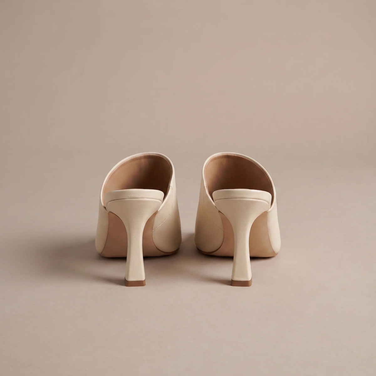 Cream square toe heeled mules, back view