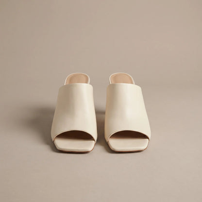 Cream square toe heeled mules, front view