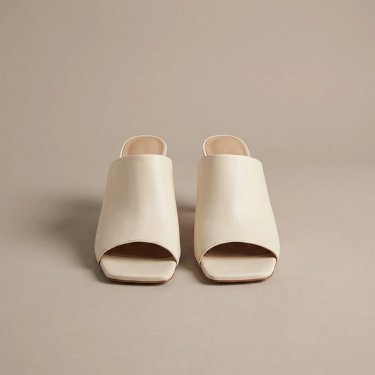 Cream square toe heeled mules, front view