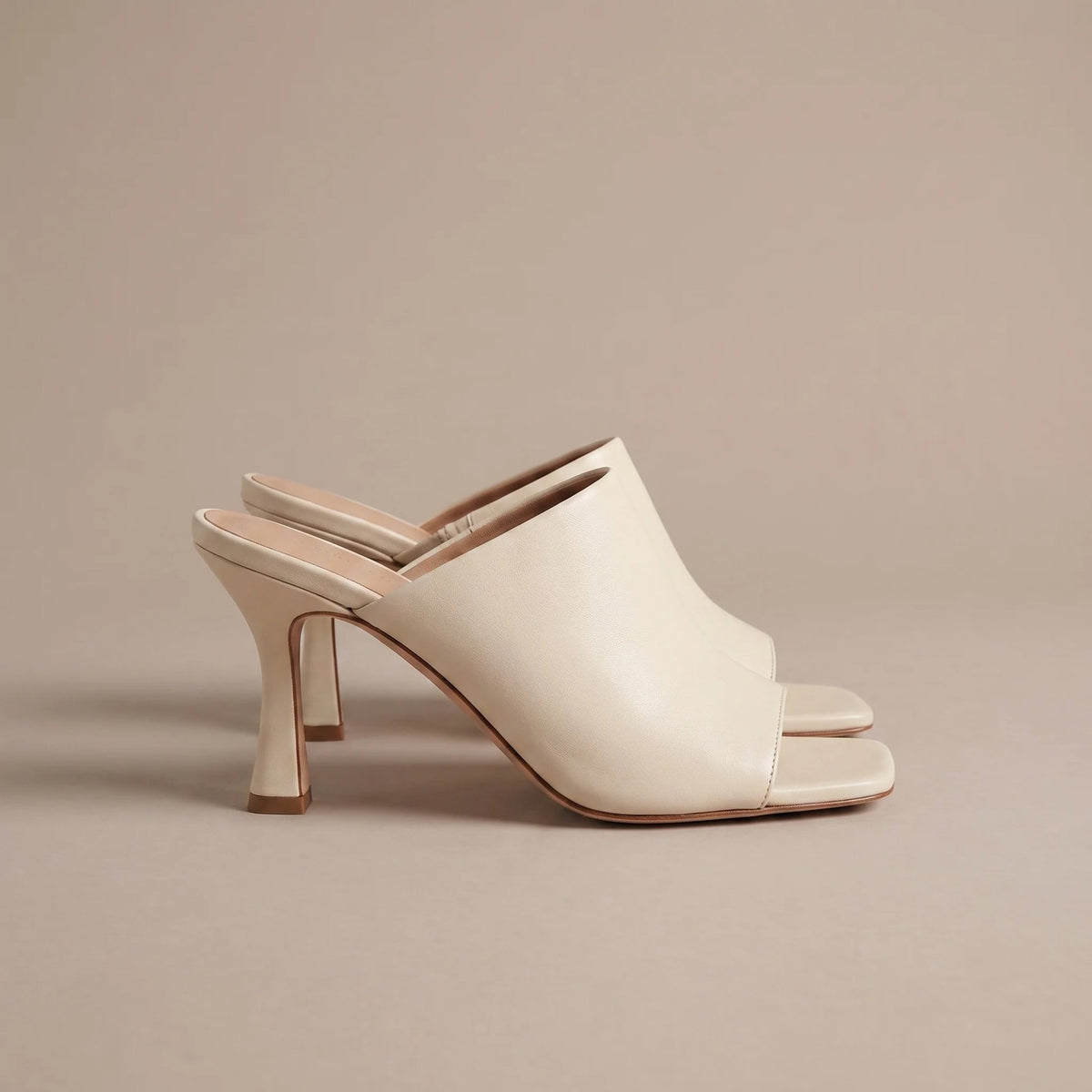 Cream square toe heeled mules, side view